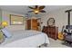 Bedroom features a window, ceiling fan and view of the living room at 15535 Allmand Dr, Hudson, FL 34667