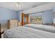 Comfortable bedroom featuring two twin beds, tile flooring, and a view of the water at 15535 Allmand Dr, Hudson, FL 34667