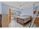 Comfortable bedroom featuring two twin beds, tile flooring, and a ceiling fan at 15535 Allmand Dr, Hudson, FL 34667
