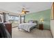 Bedroom with a ceiling fan, bright windows and comfortable carpet at 15535 Allmand Dr, Hudson, FL 34667