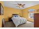 Comfortable bedroom with ceiling fan, carpet, and natural lighting at 15535 Allmand Dr, Hudson, FL 34667