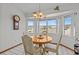 Bright breakfast nook with large bay windows and a table with chairs at 15535 Allmand Dr, Hudson, FL 34667