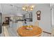 Bright breakfast nook with a round table and four chairs situated next to the open kitchen at 15535 Allmand Dr, Hudson, FL 34667