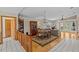 Open floor plan with dining and living room featuring hardwood floors and natural light at 15535 Allmand Dr, Hudson, FL 34667