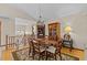 Bright dining room with wood table, chairs and an area rug on hardwood floors at 15535 Allmand Dr, Hudson, FL 34667