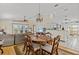 The dining area features a table and chairs with hardwood floors and a decorative area rug at 15535 Allmand Dr, Hudson, FL 34667