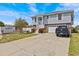 Charming two-story home with a well-maintained lawn, two-car garage, and inviting entryway at 15535 Allmand Dr, Hudson, FL 34667
