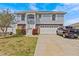 Charming two-story home with a well-maintained lawn, two-car garage, and inviting entryway at 15535 Allmand Dr, Hudson, FL 34667