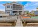 Exterior view of waterfront home with spacious deck, boat lift, and canal access at 15535 Allmand Dr, Hudson, FL 34667