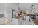 Spacious kitchen with an island, granite countertops, white cabinets and stainless steel appliances at 15535 Allmand Dr, Hudson, FL 34667