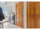 Laundry room with a washer and dryer next to two wooden doors at 15535 Allmand Dr, Hudson, FL 34667