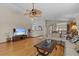 Inviting living room with hardwood floors, fan, and neutral paint at 15535 Allmand Dr, Hudson, FL 34667