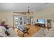Spacious living room with wood floors and access to the bedroom at 15535 Allmand Dr, Hudson, FL 34667