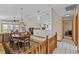 Open-concept living and dining area featuring stylish furniture, tile flooring, and ample natural light at 15535 Allmand Dr, Hudson, FL 34667
