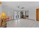 Spacious living room with tile flooring, ceiling fan, and access to the outdoor patio at 15535 Allmand Dr, Hudson, FL 34667