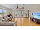 Bright living room featuring wood floors, fan, and patio doors at 15535 Allmand Dr, Hudson, FL 34667