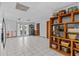 Spacious living room with tile flooring, ceiling fan, and access to the outdoor patio at 15535 Allmand Dr, Hudson, FL 34667