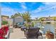 Waterfront patio with comfortable seating, shed, and picturesque canal views at 15535 Allmand Dr, Hudson, FL 34667