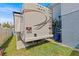 Backside of an RV parked on grass next to a home at 15535 Allmand Dr, Hudson, FL 34667
