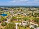 Community aerial view featuring golf course, lakes, and neighborhood at 18441 Whitacre Cir, Hudson, FL 34667