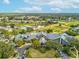 Aerial view of the clubhouse, golf course, and surrounding community at 18441 Whitacre Cir, Hudson, FL 34667