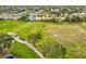 Expansive view of the community golf range and putting greens surrounded by single Gathering homes at 18441 Whitacre Cir, Hudson, FL 34667