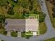 Aerial view of the property highlighting the screened-in porch and landscaping at 18441 Whitacre Cir, Hudson, FL 34667