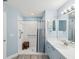 Clean bathroom featuring a glass shower, vanity, and modern fixtures in light blue decor at 18441 Whitacre Cir, Hudson, FL 34667