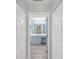 Bathroom view through doorway featuring vanity with blue cabinets and well lit mirrors at 18441 Whitacre Cir, Hudson, FL 34667