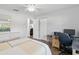 Bright bedroom featuring wood floors, a dresser with a mirror and a desk with computer at 18441 Whitacre Cir, Hudson, FL 34667