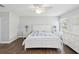 Comfortable bedroom featuring a large bed, bedside tables and dresser with natural light from the windows at 18441 Whitacre Cir, Hudson, FL 34667