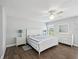 Bright bedroom with a ceiling fan, a large bed, and coordinated bedside tables and dresser at 18441 Whitacre Cir, Hudson, FL 34667