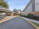 Beautiful community center entrance with covered drop-off, porte-cochere, brick accents and lush landscaping at 18441 Whitacre Cir, Hudson, FL 34667