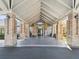 Community center entrance featuring brick columns, a covered entryway, and manicured grounds at 18441 Whitacre Cir, Hudson, FL 34667