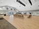 Large open event hall features wood flooring, neutral walls, and high ceilings ready for entertainment and community events at 18441 Whitacre Cir, Hudson, FL 34667