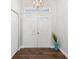 Inviting foyer features beautiful flooring, a statement chandelier, and natural light at 18441 Whitacre Cir, Hudson, FL 34667