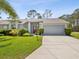 Inviting single-story home with well-kept lawn, mature landscaping, and a two-car garage at 18441 Whitacre Cir, Hudson, FL 34667