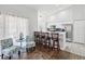 Modern kitchen area with bar seating, white cabinetry, and stainless steel appliances at 18441 Whitacre Cir, Hudson, FL 34667