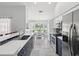 Bright and modern kitchen with stainless appliances, island sink, and breakfast nook at 18441 Whitacre Cir, Hudson, FL 34667