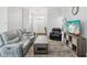 Bright living room featuring modern furnishings, hardwood floors, and access to other living areas at 18441 Whitacre Cir, Hudson, FL 34667