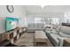 Spacious living room with plenty of seating, natural light, and a seamless flow to other living spaces at 18441 Whitacre Cir, Hudson, FL 34667