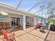 Spacious tiled patio with ceiling fan and ample seating, ideal for outdoor enjoyment at 18441 Whitacre Cir, Hudson, FL 34667