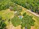 Expansive aerial shot of a private residence boasting a sparkling pool and verdant, tree-lined property at 196 Lark Ave, Brooksville, FL 34601