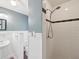 The updated bathroom showcases a sink, toilet, tiled shower, and white wainscoting with modern fixtures at 196 Lark Ave, Brooksville, FL 34601
