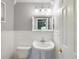 Half bathroom featuring white trim, toilet, and sink with modern faucet at 196 Lark Ave, Brooksville, FL 34601