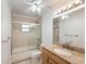 Bathroom featuring tan tile surround and a sink with wood cabinets and vanity at 196 Lark Ave, Brooksville, FL 34601