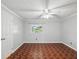 Spacious bedroom with a ceiling fan and a large window overlooking the backyard at 196 Lark Ave, Brooksville, FL 34601