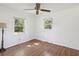 Bedroom with neutral walls, hardwood floors, ceiling fan, and large windows at 196 Lark Ave, Brooksville, FL 34601