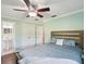 Bedroom featuring wood floors, ceiling fan, and a modern wooden bedframe at 196 Lark Ave, Brooksville, FL 34601