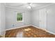 This charming bedroom features gray walls, natural lighting, and unique flooring patterns at 196 Lark Ave, Brooksville, FL 34601
